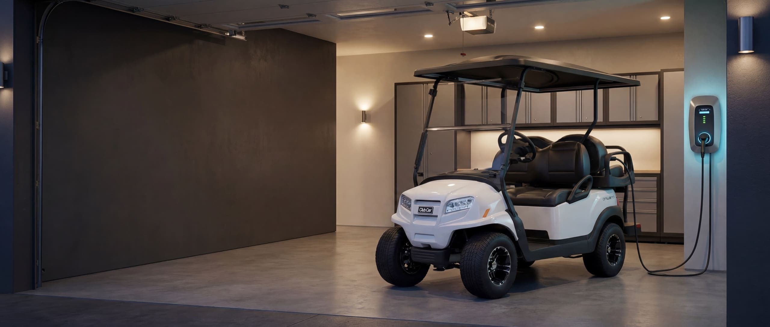 A white Club Car Onward plugged into its wall charger in a clean modern garage at dusk